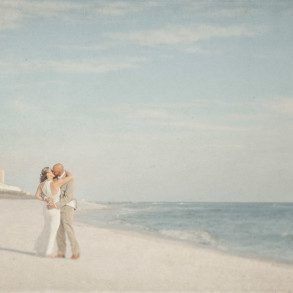 Newlyweds kiss on beach at Florida destination wedding