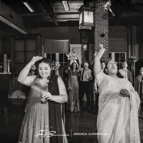 Lesbian couple toss their bouquets at their wedding reception